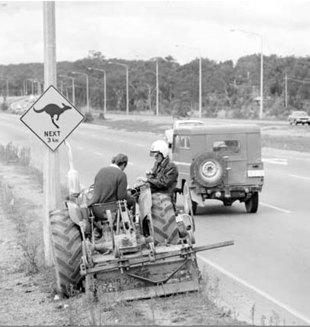 Policeman booking tractor driver