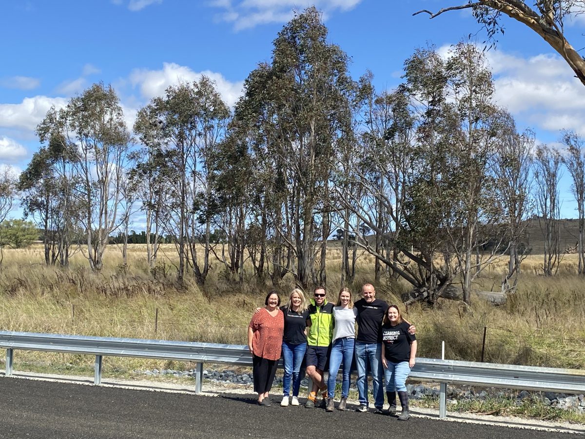 Murrumbateman business owners linking arms on a road