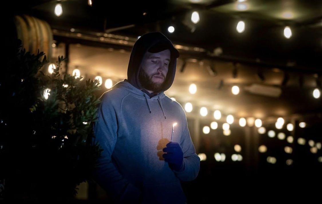 Person holding candle at The Dock's dawn service