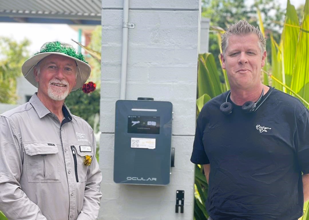 twomen standing next to a car charger