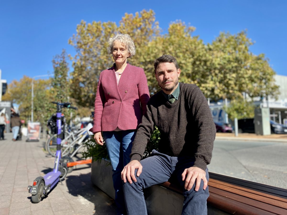 woman and man next to a bench