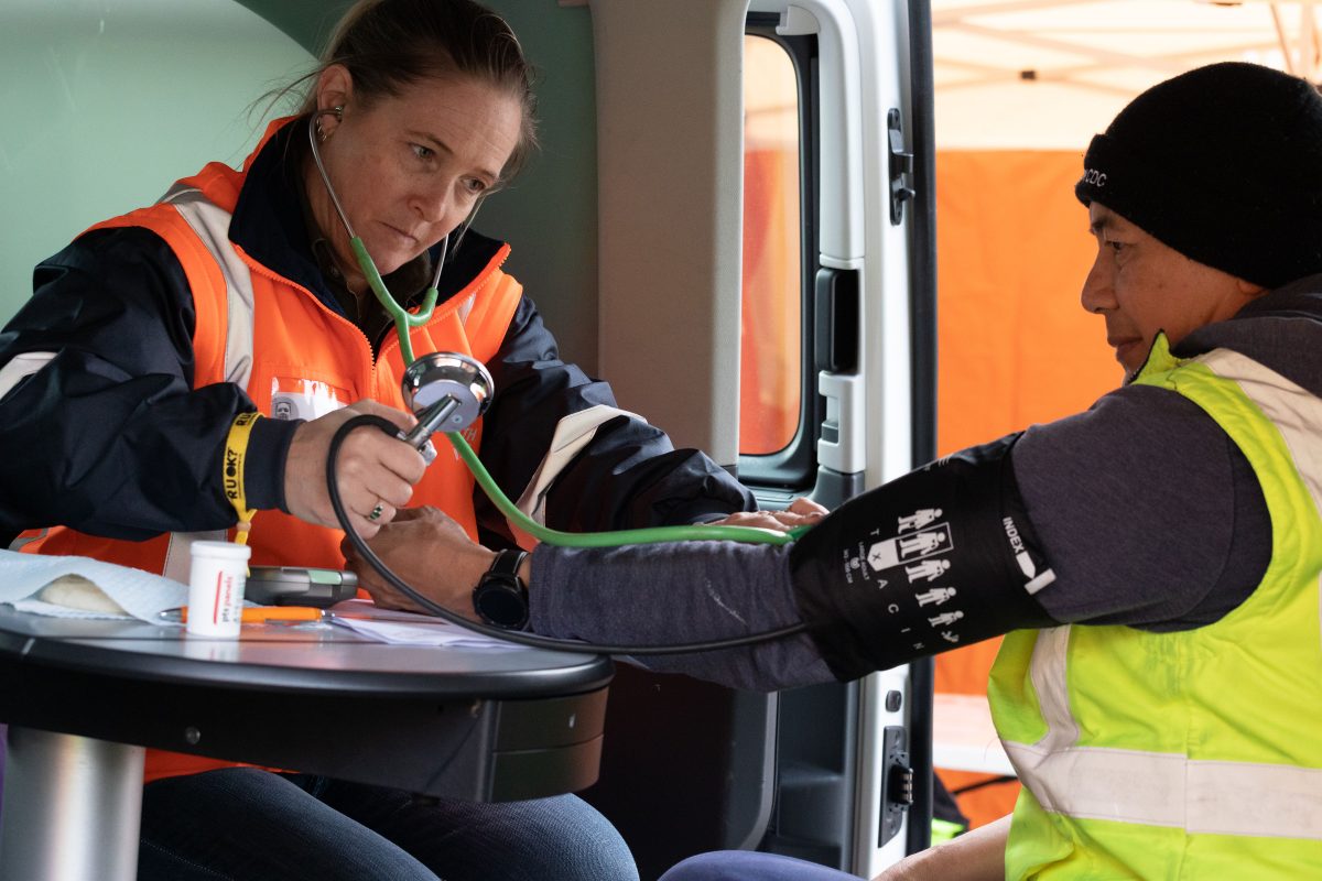 OzHelp nurse takes an employee's blood pressure during a Workplace Tune Up