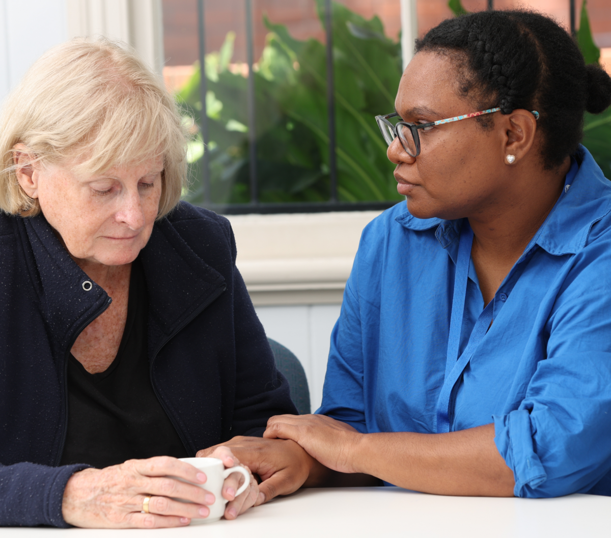 Senior women is comforted by a Saint Vincent de Paul volunteer