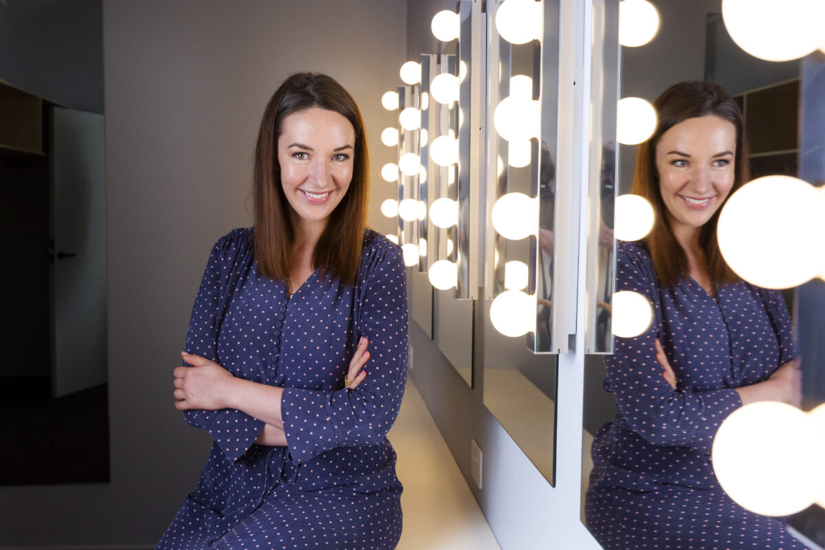 Woman in front of mirrors