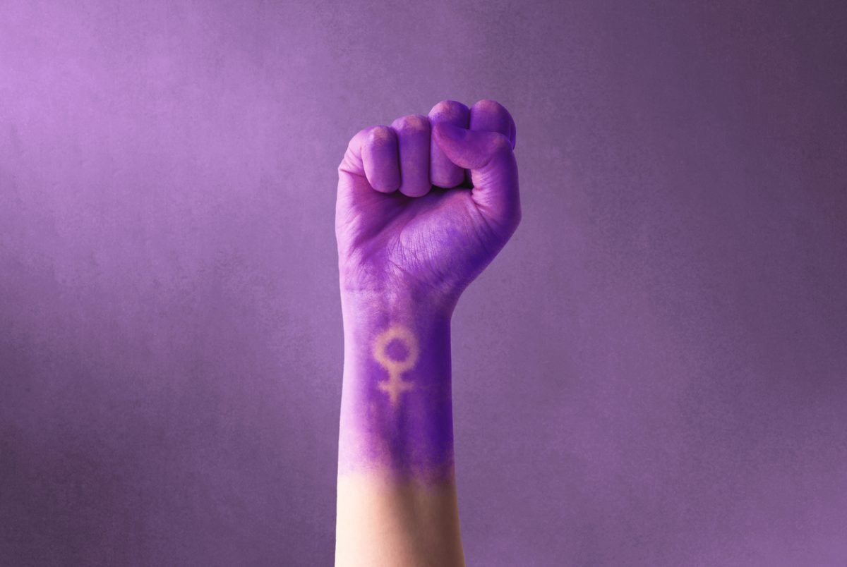 raised fist covered with purple dye