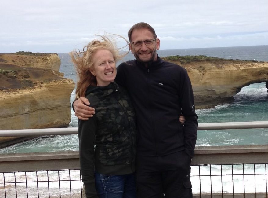 woman and man standing near a rail