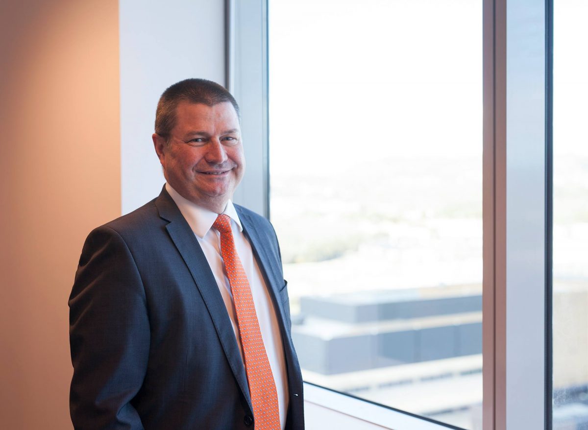 man in suit standing near a window