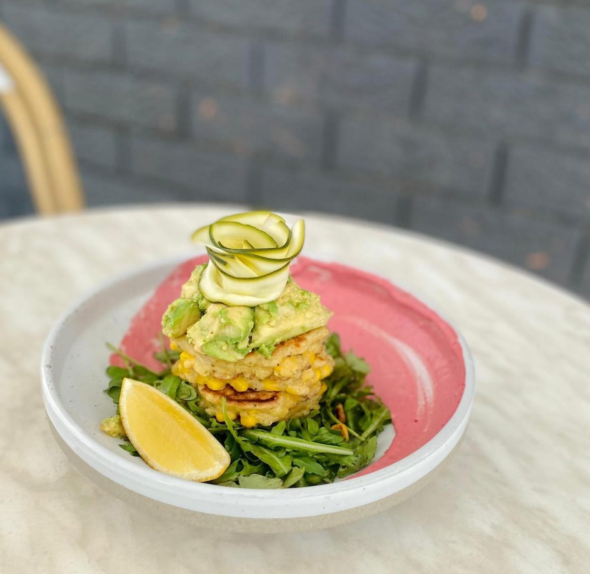 corn fritters on pink plate