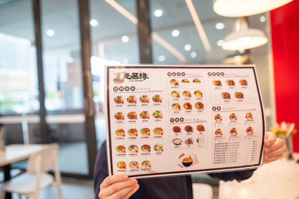 menu held in front of a face