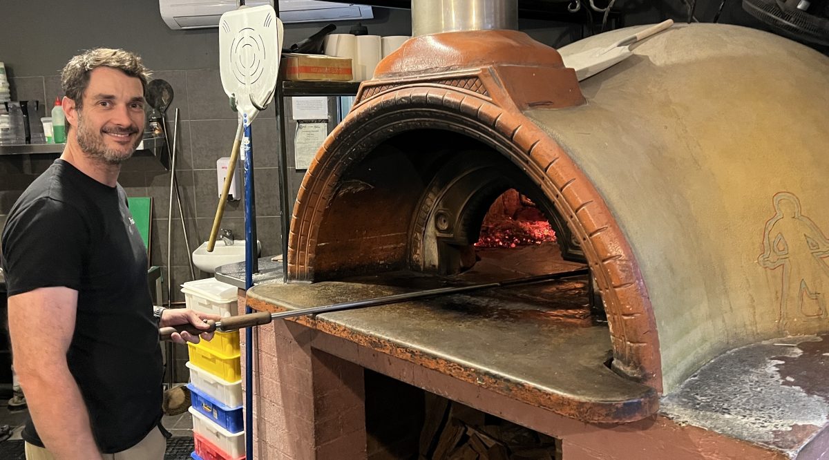 man at pizza oven