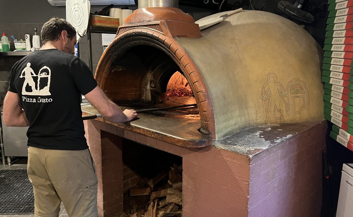 man at pizza oven