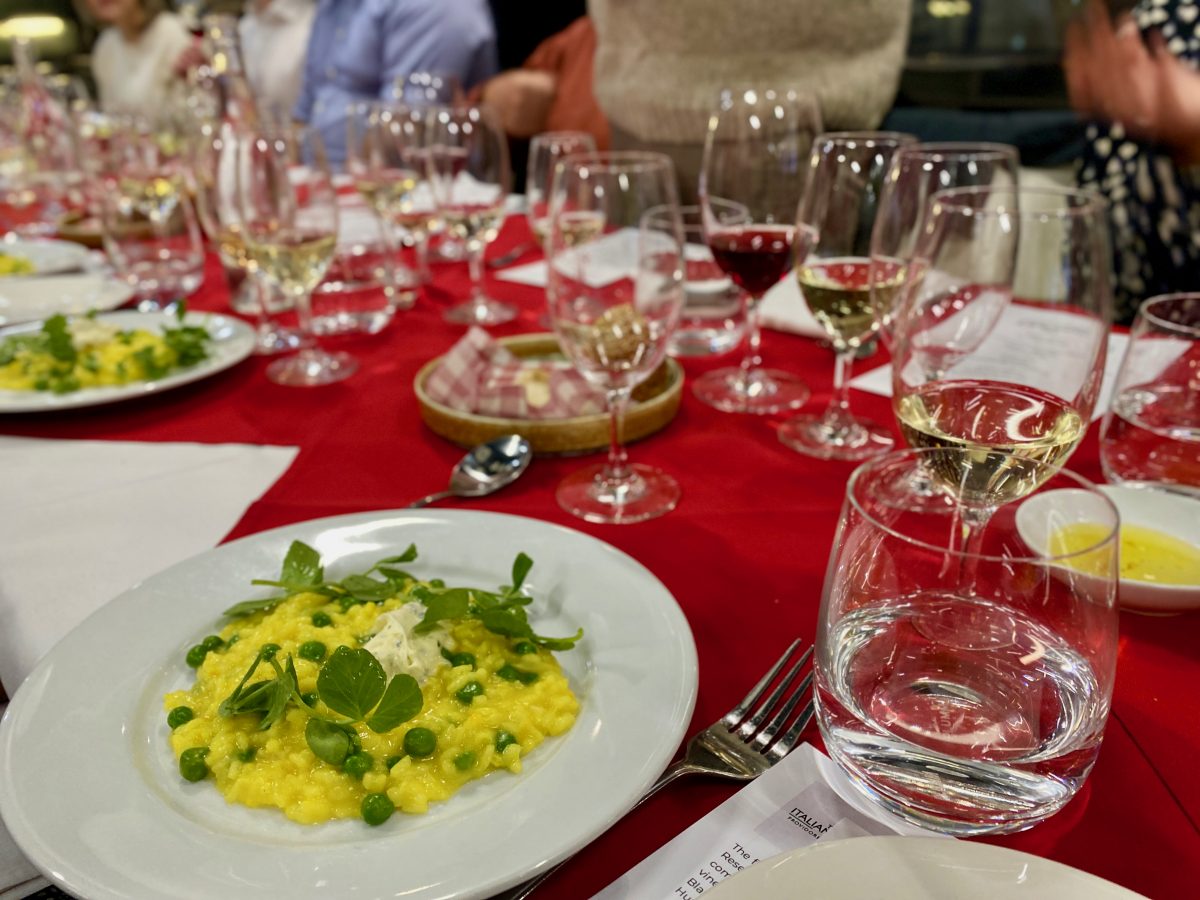 Plate of yellow risotto with green peas