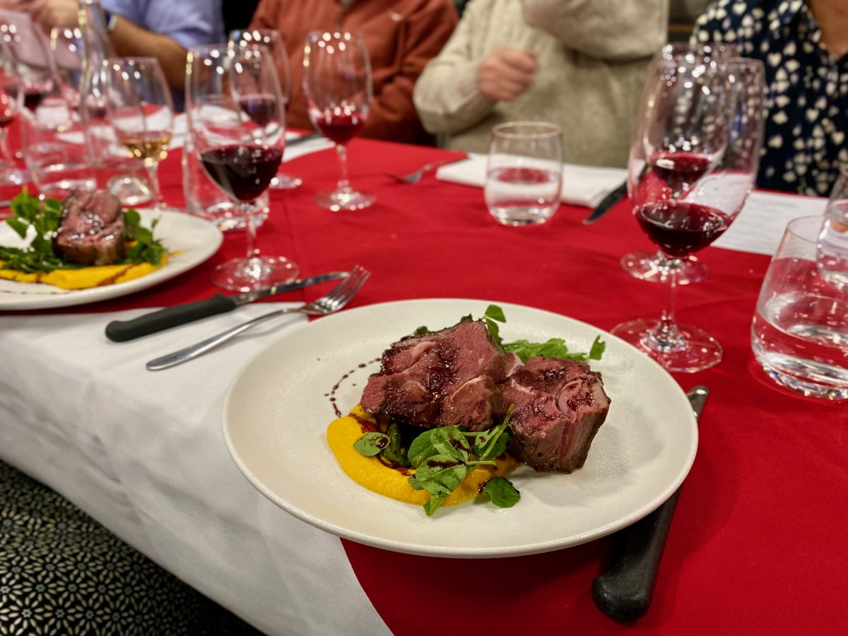 plate of lamb on long table