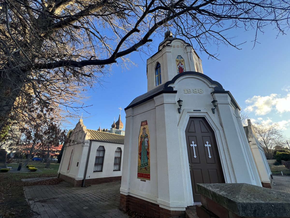 Corner shot of the Ukrainian Church with trees around its periphery.