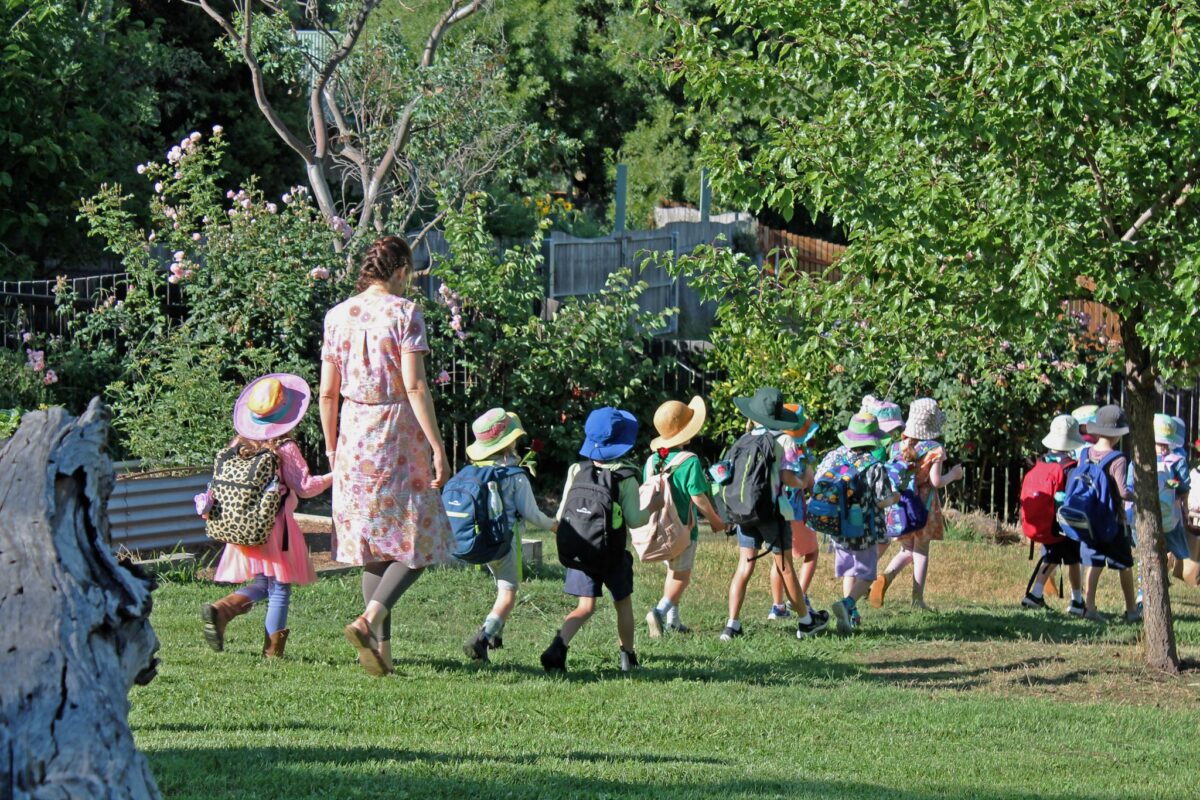 line of children and teacher