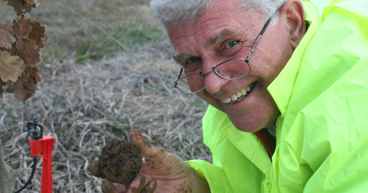 Wayne wearing high vis and holding a truffle,