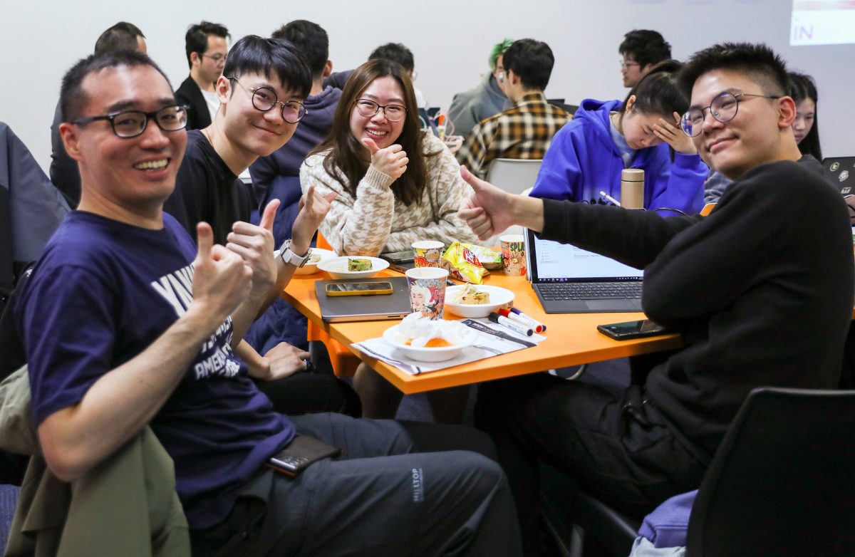 table of students working at hackathon