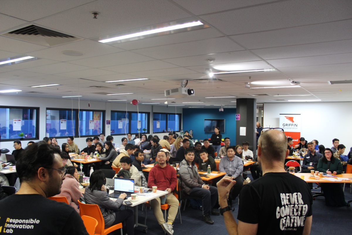 room filled with working students at hackathon