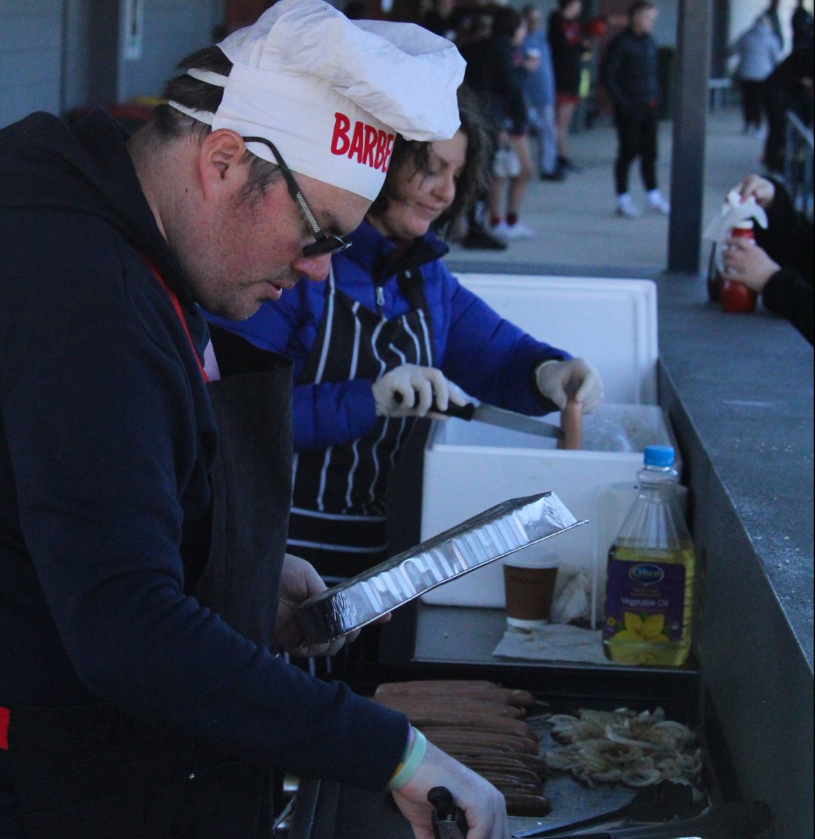 Eastlake Football Club volunteer Ben Parker at a barbecue 