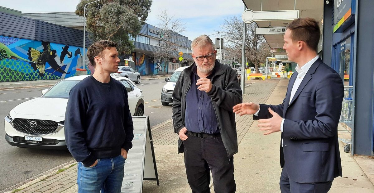 there men on shops footpath