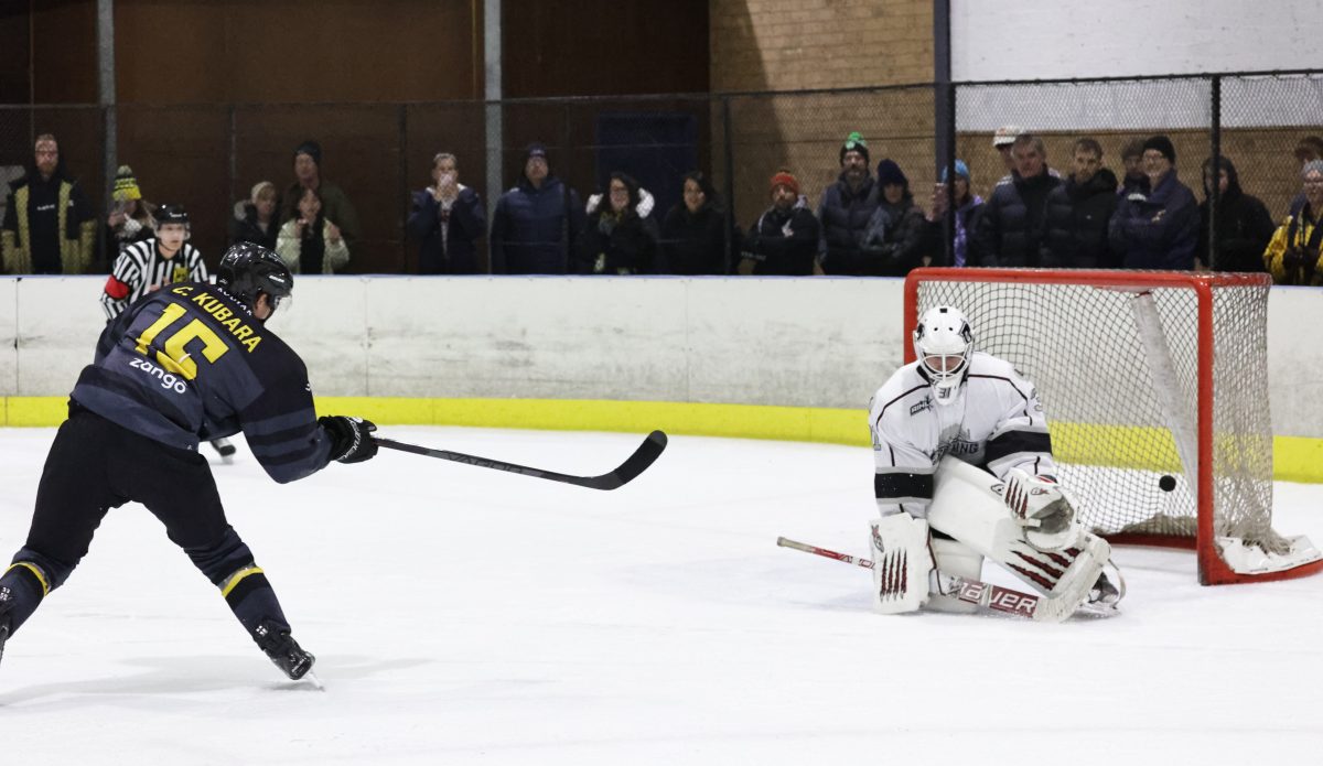Casey Kubara scores a goal on the ice hockey rink