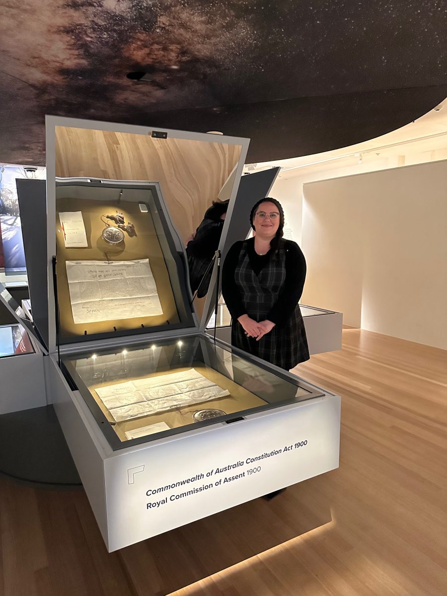 Woman next to display case