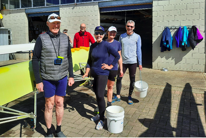 Canberra Rowing Club Masters Quad Scull wash their boat in front of the Club’s Boatshed at Yarralumla Bay. Crew members from left are Pat Davoren, Ruth Mills, Judy Schneider and Bruce Cooper. 