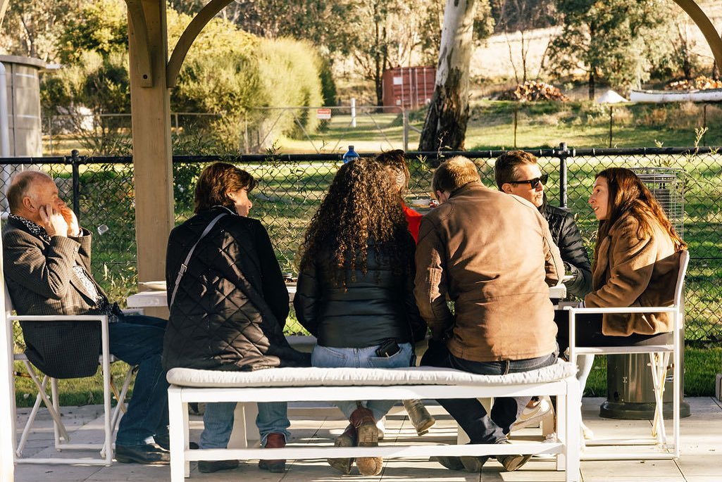 A group of people sitting at a table outside the Old Bookham Church/Facebook