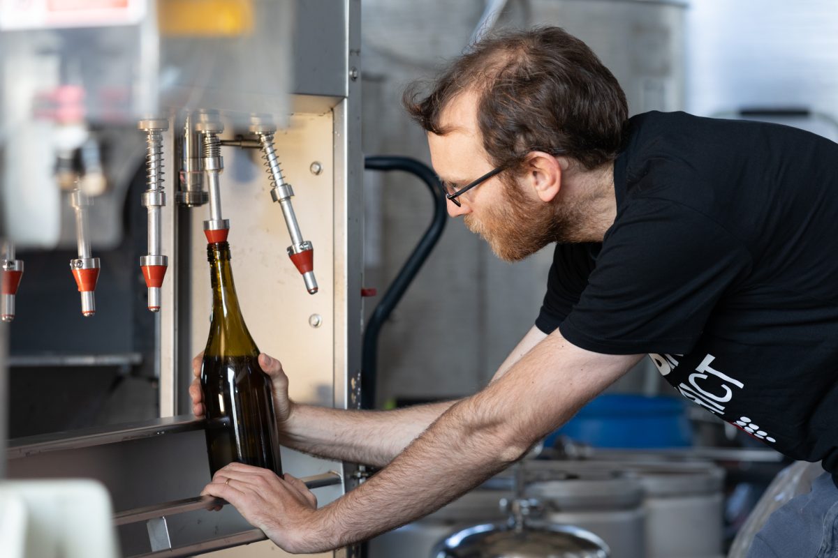 Man filling wine bottle