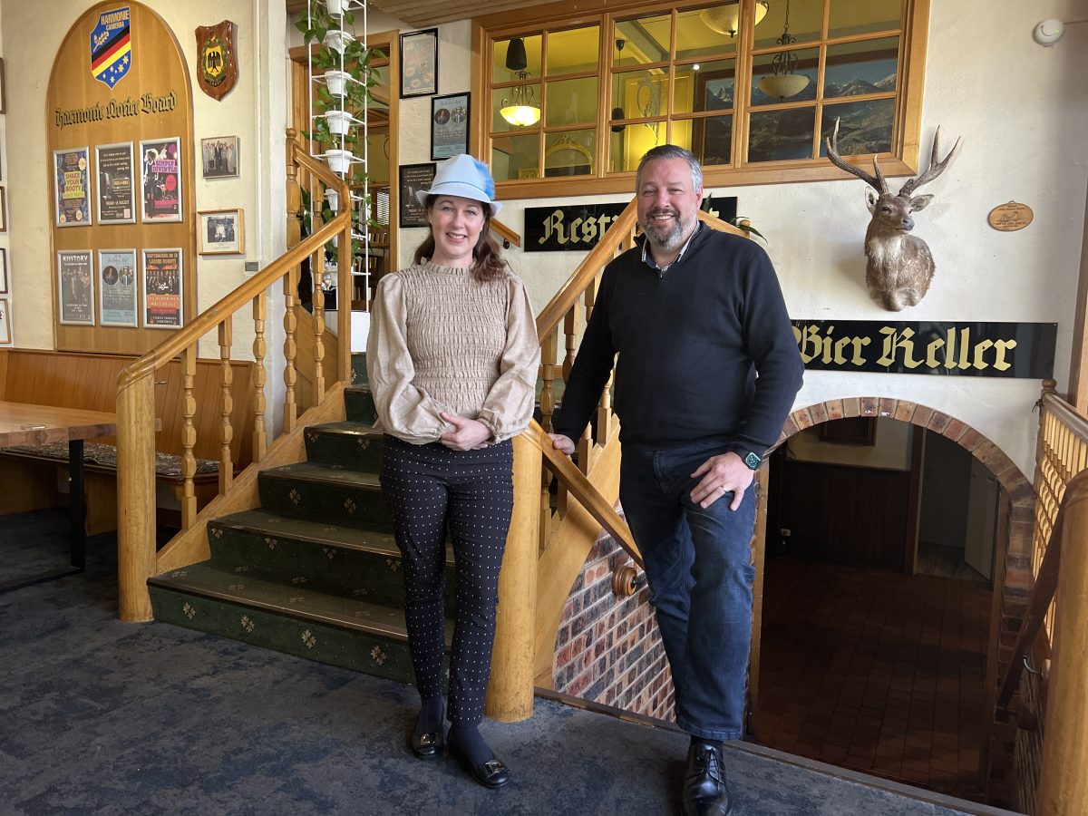 Two people standing in the Harmonie German Club in Canberra