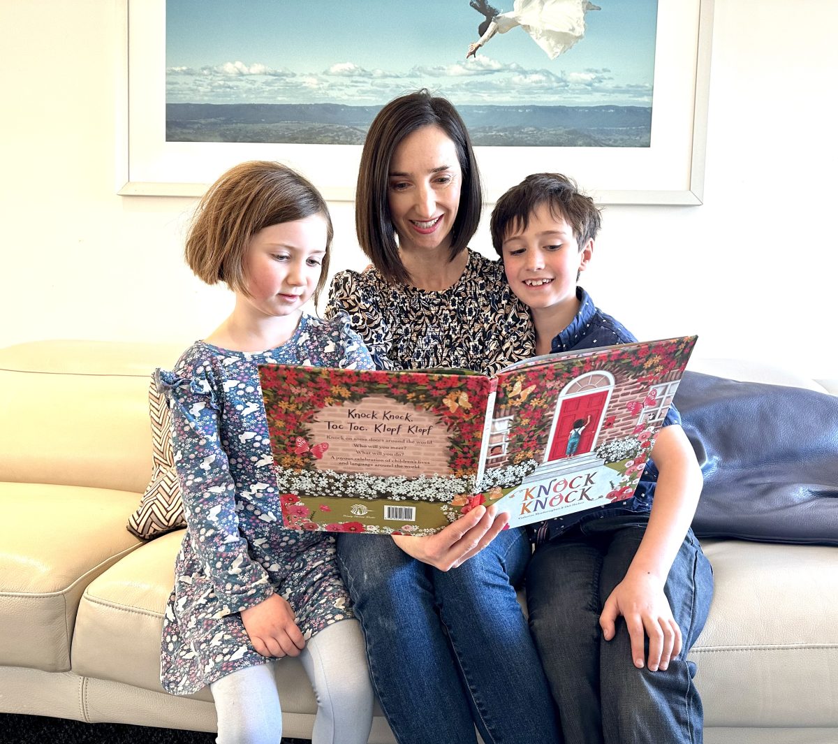 Woman reading to two kids