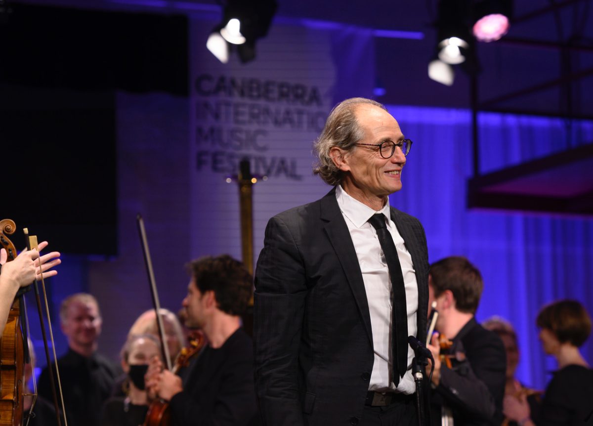 man standing near orchestra