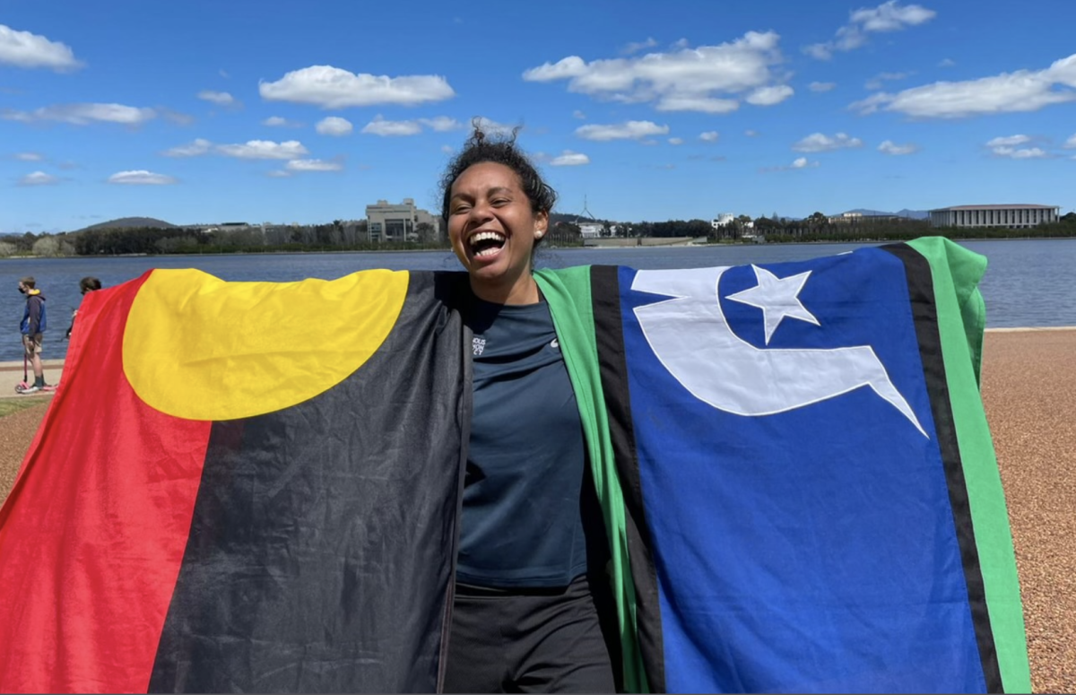 Aboriginal woman with flags on Lake Burley Griffin