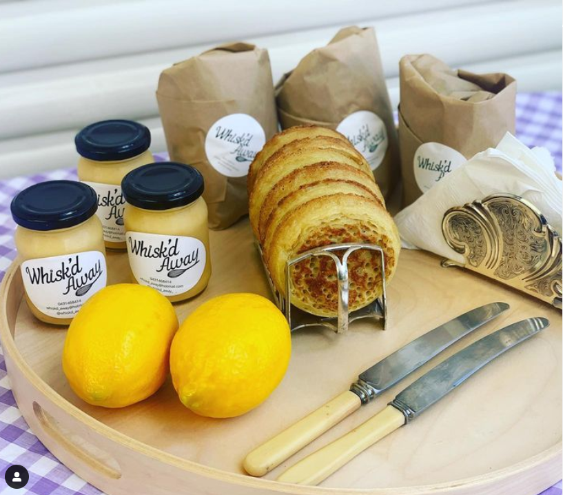 a tray with toasted crumpets, lemon butter and lemons.