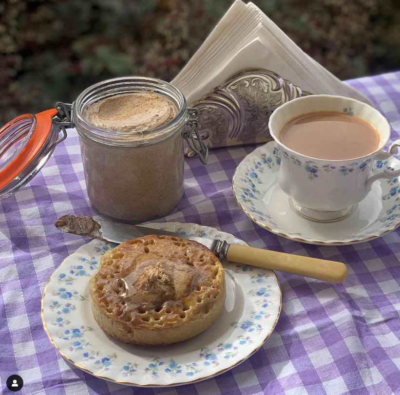 a crumpet with melting cinnamon butter and a cup of tea