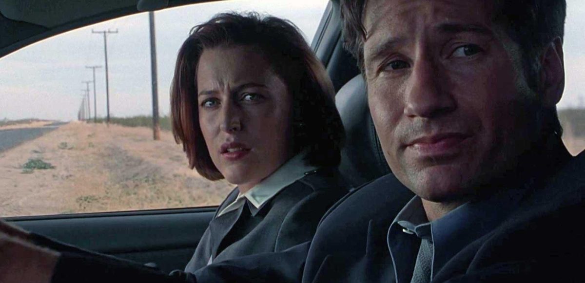 X-Files screengrab of two people sitting in a car looking out the window