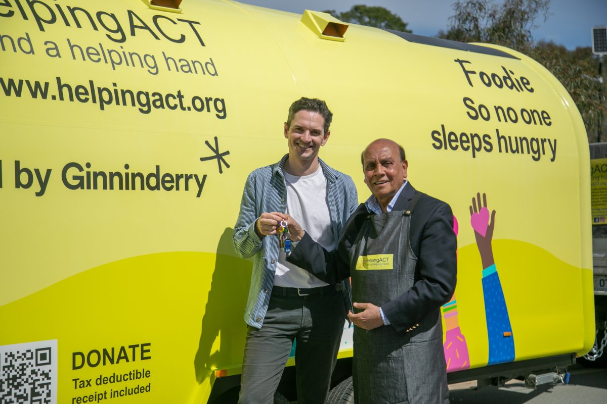 Marcus Mills-Smith hands over Foodie's keys to HelpingACT founder Mohammed Ali. 