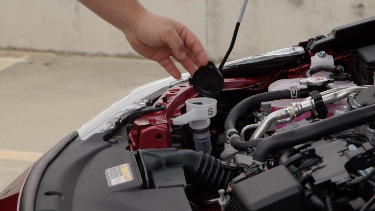 opening the cap of the wiper fluid reservoir in a car