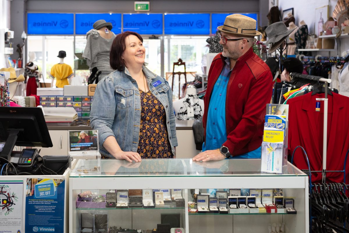 Jo Schirmer and Gary Crowder standing behind the counter in a Vinnies store