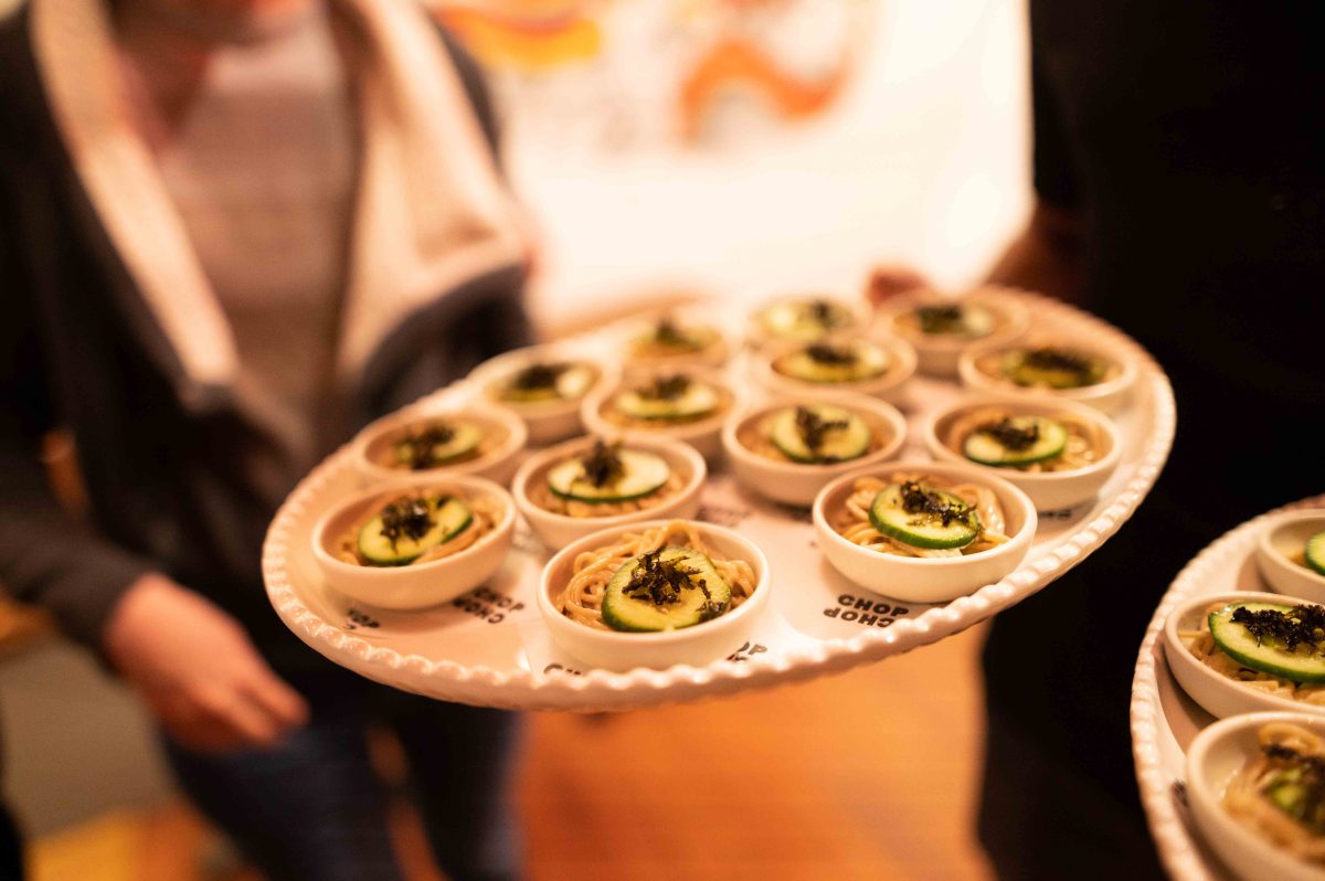 Small bowls of noodles topped with cucumber and seaweed