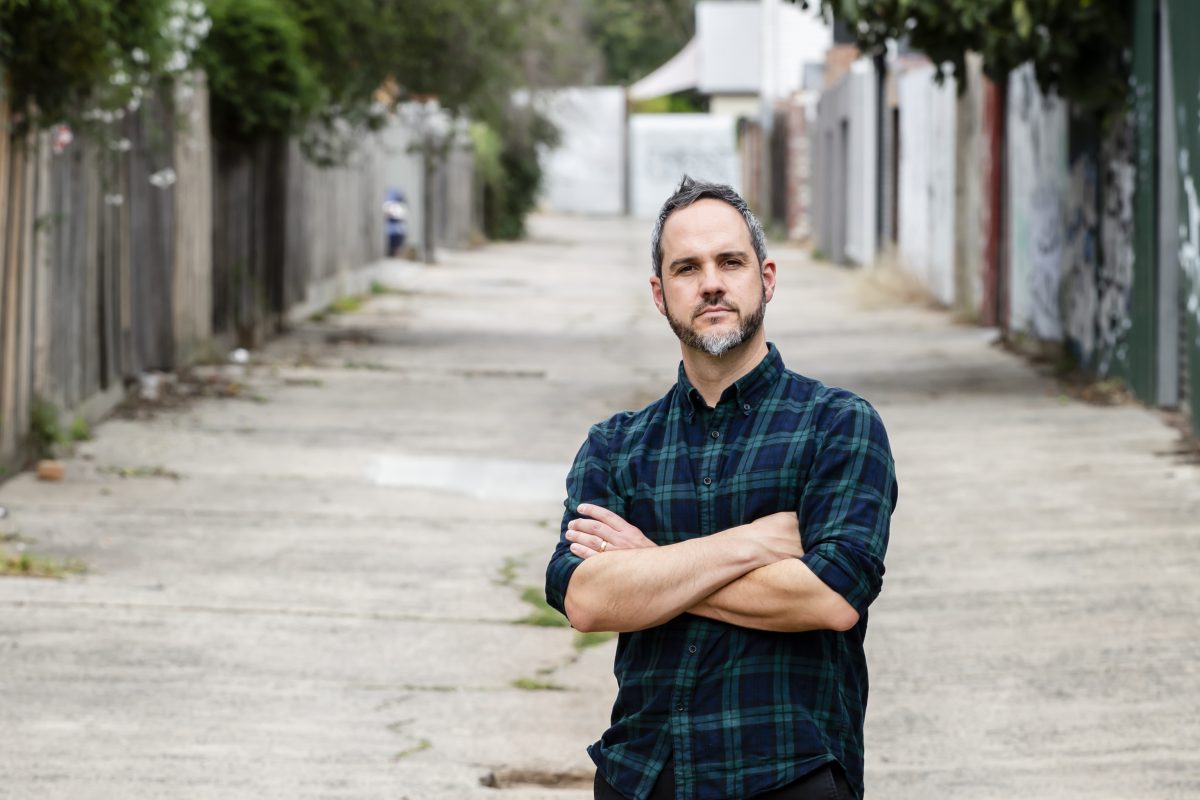 man standing in laneway