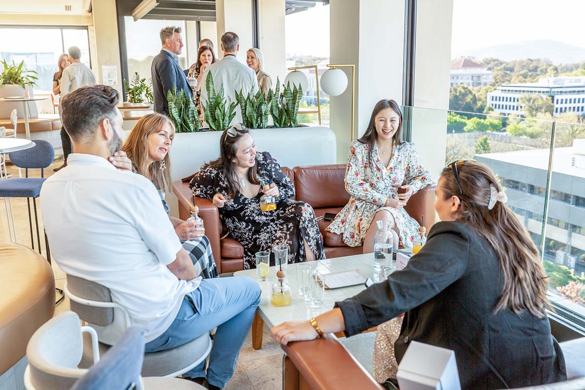 guests at Leyla Bar sitting on chairs around a table and laughing