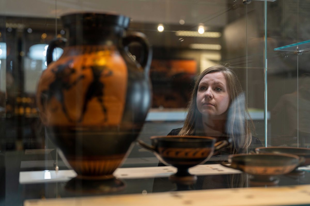 woman looking at vase at the ANU Classics Museum