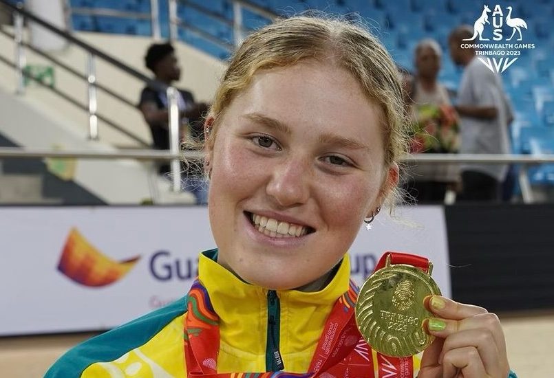 Lauren Bates holding a gold medal