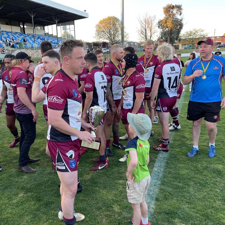 Kangaroos captain-coach Sam Williams carrying a trophy