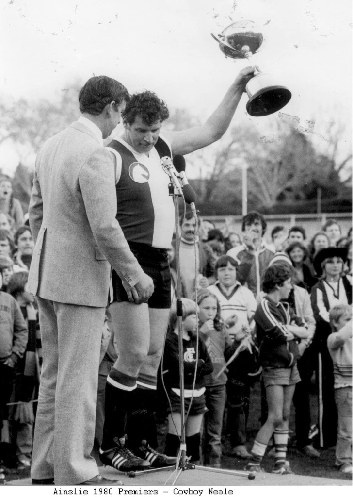 Man holding a trophy aloft