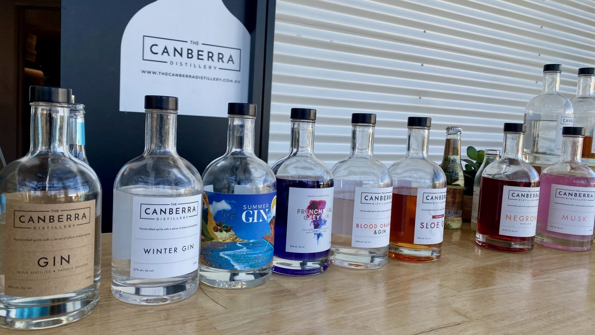 several different bottles of gin with Canberra Distillery logo in the background