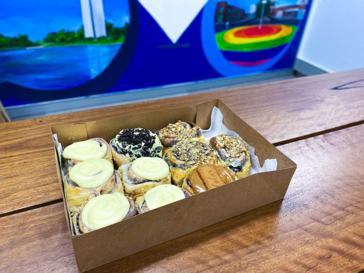 A box of tasty looking cinnamon swirls against a colourful background