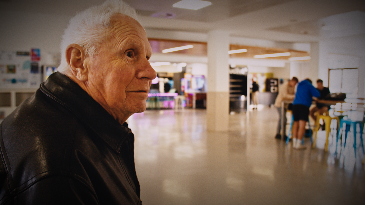 man looking at a student hall