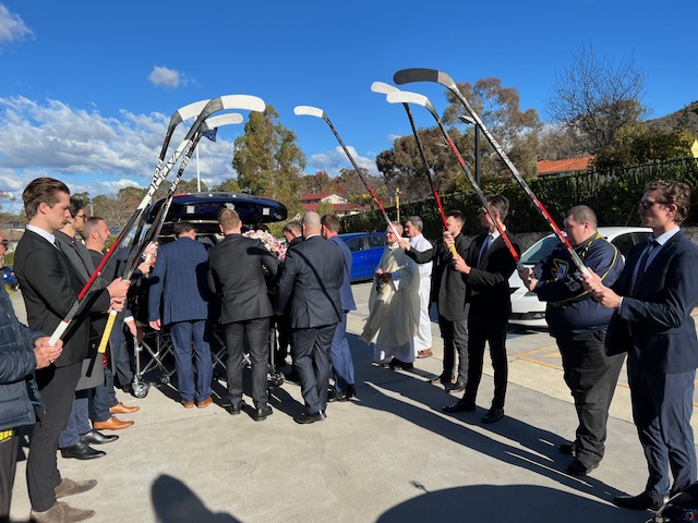 guard of honour as a coffin is put into a hearse